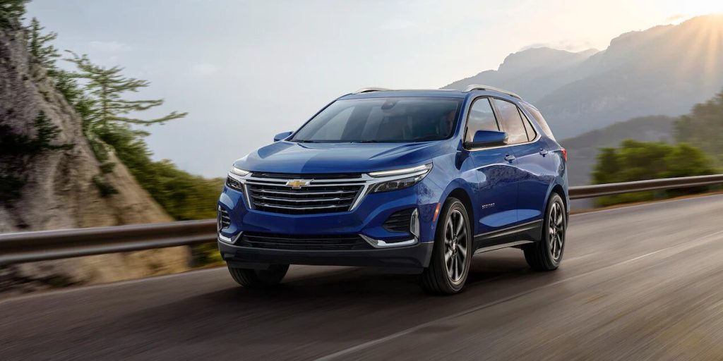 Blue 2022 Chevrolet Equinox driving down a mountain highway.