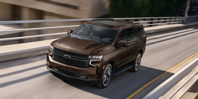 A brown 2022 Chevrolet Tahoe zooming down a highway road.